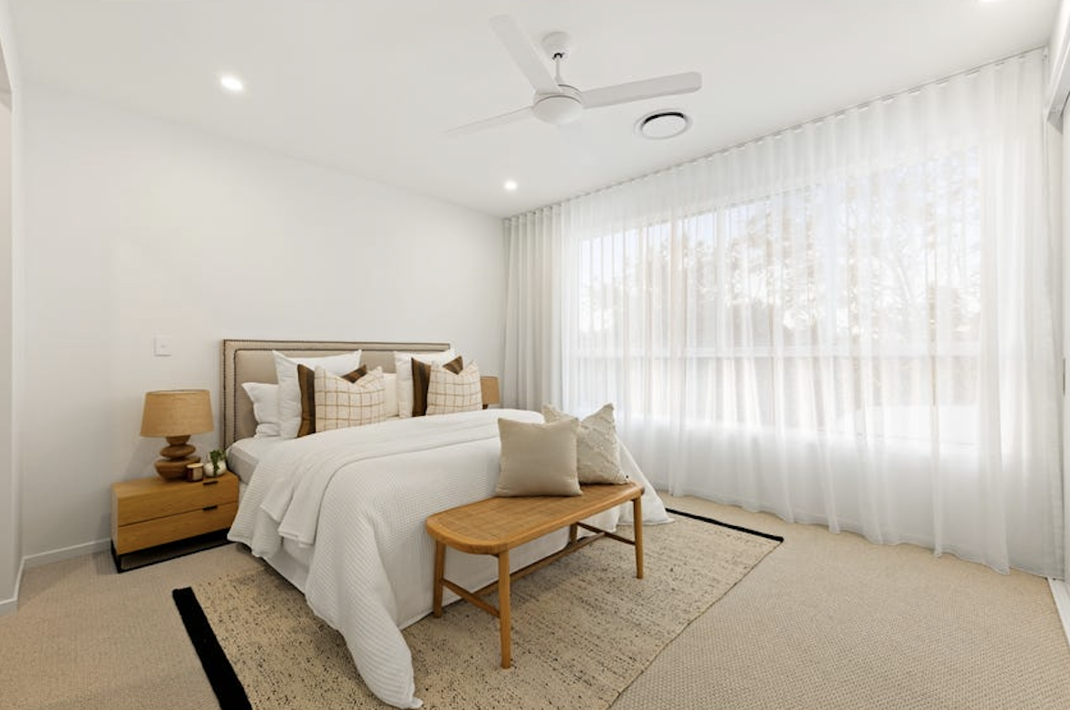 master bedroom with fresh white linen and coastal furniture, property styling by blink living